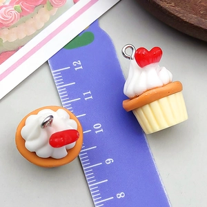 Resin cupcake charms in white and orange with heart detail and silver rings for DIY jewelry