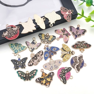 Detail of colorful enamel butterfly pendants with gold metal bases for DIY jewelry