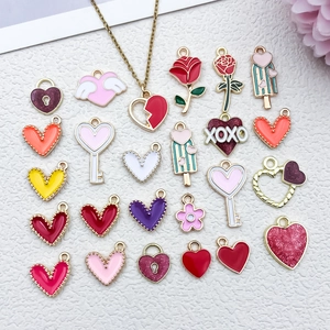 Macro view of assorted heart and rose enamel charms for DIY jewelry making sets