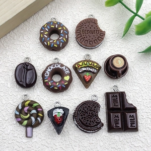 Detailed macro view of assorted resin chocolate dessert charms with metal hanging loops