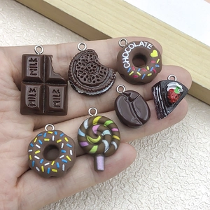 Handheld set of 7 miniature resin dessert charms including Oreo and chocolate donut styles