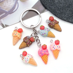 Flat lay of colorful resin strawberry ice cream cone charms for DIY jewelry and keychains