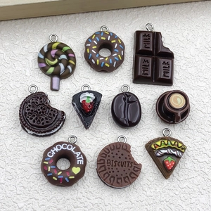 Macro shot of resin dessert pendants including donuts and chocolate charms for DIY crafts