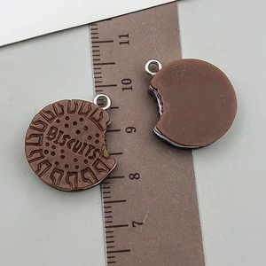 Macro view of realistic biscuit resin pendant with BISCUITS engraving and bite marks