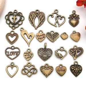 Macro shot of assorted vintage bronze alloy heart charms for DIY jewelry crafting