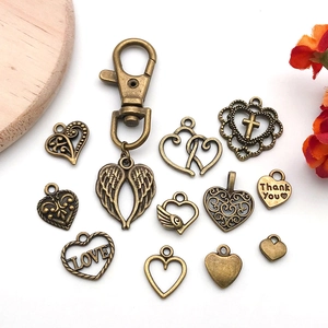 Antique bronze heart pendants with wing charms and LOVE engraving for DIY jewelry