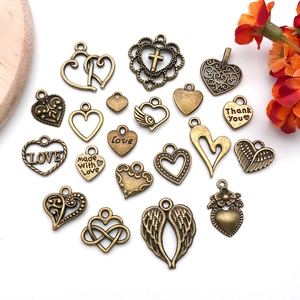 Macro shot of 19 vintage bronze alloy heart charms for DIY jewelry making accessories