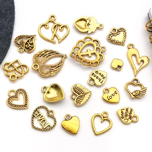 Macro view of assorted vintage gold alloy heart charms for DIY jewelry making