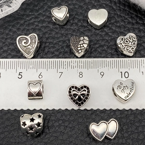Antique silver heart-shaped love beads and assorted charms for DIY bracelet making
