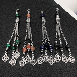 Close-up of alloy tassel charms with Celtic knots and colorful agate beads in four colors
