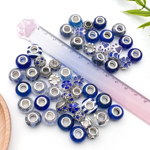 Detailed view of dark blue resin beads and silver alloy charms for DIY bracelet making