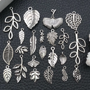Macro view of assorted vintage silver alloy leaf charms for DIY jewelry making