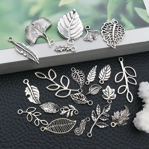 Macro shot of assorted silver alloy leaf charms for DIY necklaces and earring jewelry