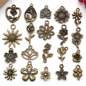 Macro view of vintage bronze alloy floral charms for DIY jewelry making and crafts