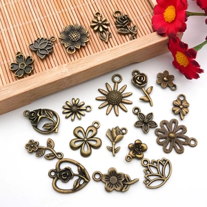 Macro detail of antique bronze alloy floral charms for DIY jewelry making accessories