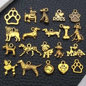 Detailed macro view of twenty vintage gold alloy dog themed charms for DIY jewelry making