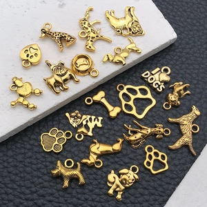 Macro shot of assorted golden alloy dog charms including poodle bulldog and bone shapes