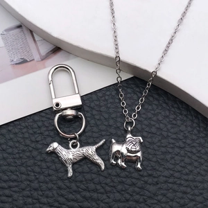Detailed macro view of dog-shaped alloy pendants and keychain with fine engraved texture