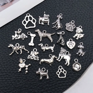 Detailed collection of antique silver dog charms including bulldog and bone shapes