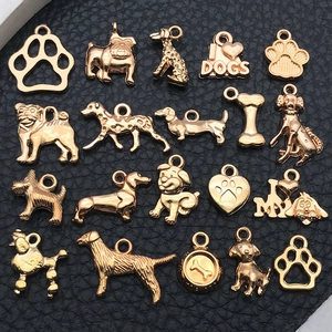 20pcs gold-plated dog charms set for DIY jewelry making on black leather background