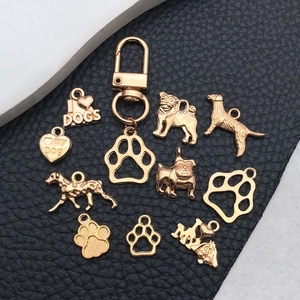 Golden pet-themed DIY charm set with dog breeds, heart tags, and paw prints for jewelry