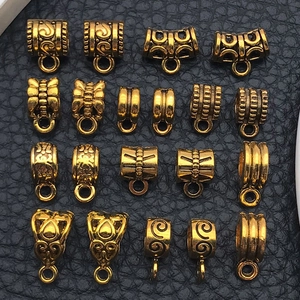 Macro view of vintage gold alloy spacer beads and pendant connectors for DIY jewelry