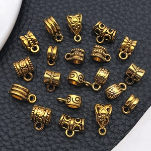Macro shot of antique gold bails with embossed textures for DIY jewelry making
