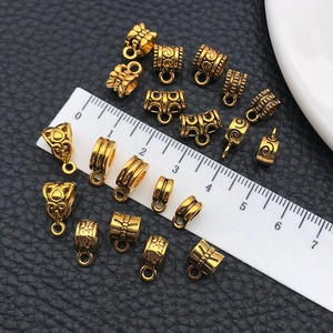 Detail of vintage gold jewelry connectors with ornate patterns on black leather