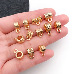 Set of 12 gold plated charm bails with assorted floral and butterfly patterns for bracelets