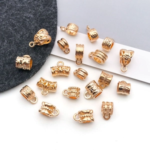 Macro view of gold-plated alloy pendant connectors with embossed vintage patterns