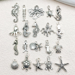 Macro view of 19 assorted antique silver sea creature alloy charms for DIY jewelry making