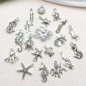 Macro detail of Tibetan silver ocean charms including seahorse starfish and turtles