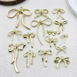 Assorted gold bow charms in various textures and designs for DIY jewelry and accessories