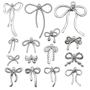 Silver bow alloy charms set in 14 minimalist and floral designs for DIY jewelry crafting