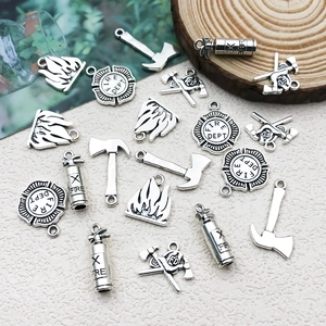 Macro view of vintage silver alloy fire department charms for DIY jewelry making