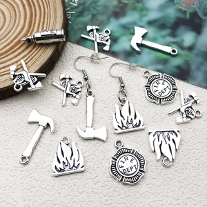 Vintage silver firefighter charms set with fire extinguisher, axe and fire dept emblem