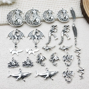 Detailed collection of antique silver animal pendants including wolf, fox and dragon motifs