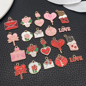 Detailed flat lay of pink and red enamel heart charms for Valentine jewelry DIY