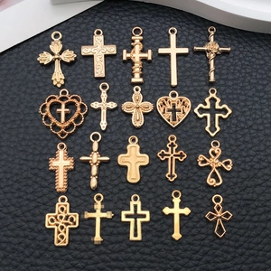 Set of 20 vintage gold cross pendants in various DIY designs on black background