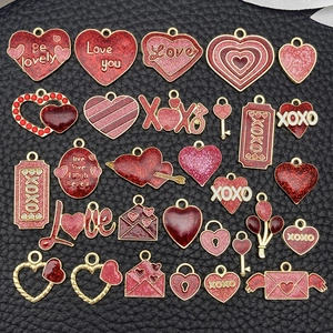 Flat lay set of 25 red and pink enamel heart charms with gold finish for DIY jewelry