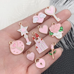 Pink heart and castle charms set in gold finish for DIY jewelry and necklaces