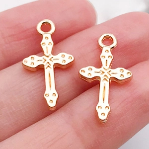 Macro detail of two vintage gold-plated alloy cross pendants for DIY jewelry making