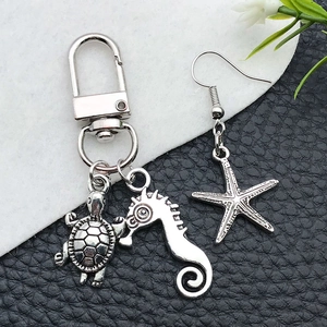 Detail of antique silver sea turtle and seahorse charms with intricate relief textures