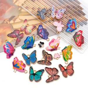 Gros plan de pendentifs papillons en émail coloré avec bords dorés pour la création de bijoux