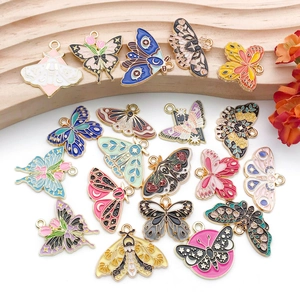 Macro shot of assorted colorful butterfly enamel charms with golden alloy edges for DIY jewelry