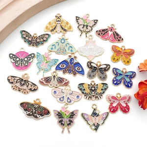 Flat lay of colorful enamel butterfly charms for DIY jewelry making on white background