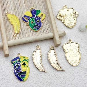 Detail of Mardi Gras alloy pendants featuring colorful feather and mask enamel charms