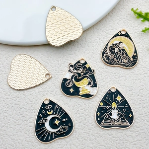 Detailed macro view of black and gold alloy tarot charms for DIY jewelry making