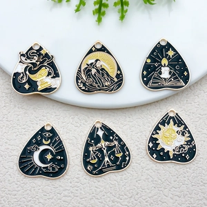 Detail showing tarot heart pendants with death, candle, crescent and sun moon enamel designs