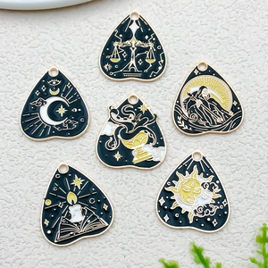 Macro view of gothic tarot charms featuring sun, moon, and scales for DIY jewelry making